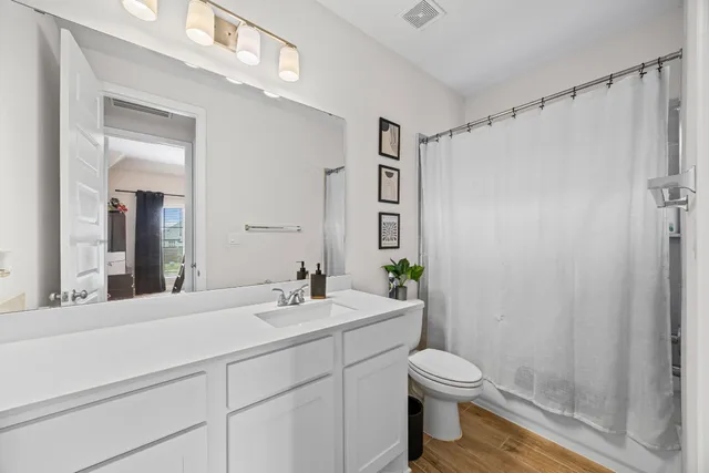 a living room with furniture a flat screen tv and a large window