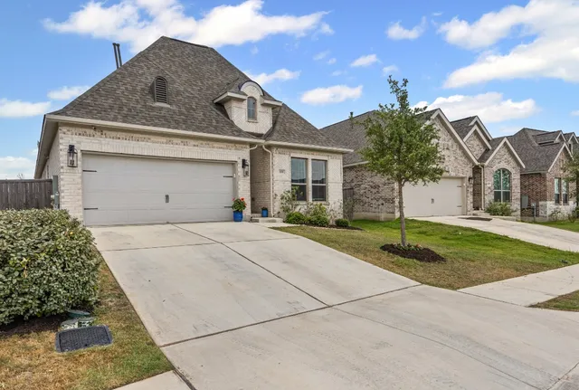 a front view of a house with a yard and garage