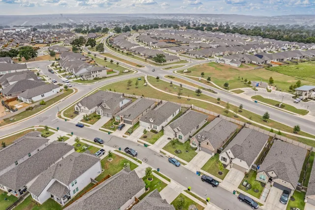 an aerial view of residential houses with outdoor space