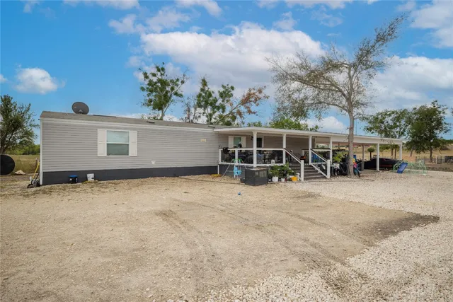 a house view with a backyard space