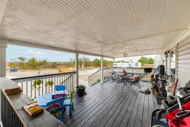 a view of a balcony with chairs and wooden floor