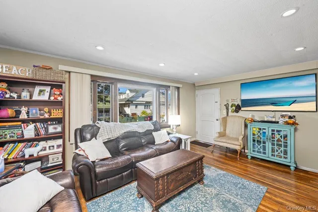 a living room with furniture a rug and a bookshelf