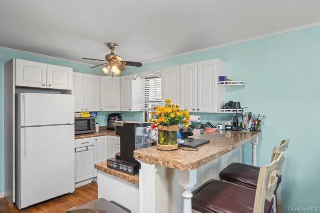 a kitchen with a refrigerator and a stove top oven