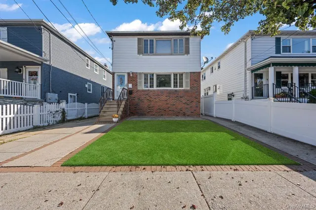 a front view of a house with a yard and porch