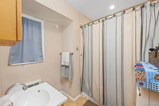 a bathroom with a shower curtain and a sink