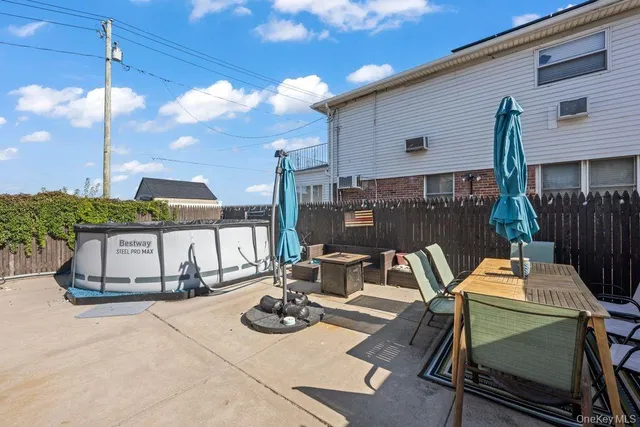 a view of a patio with table and chairs and potted plants