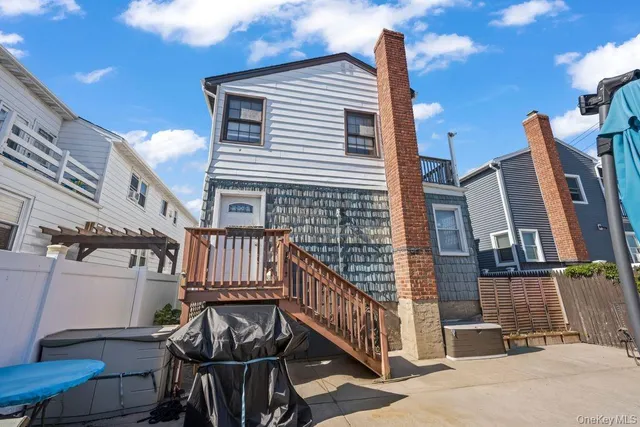 a view of a brick house with wooden fence