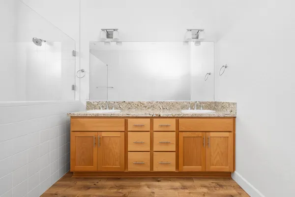 a bathroom with a granite countertop sink and a mirror