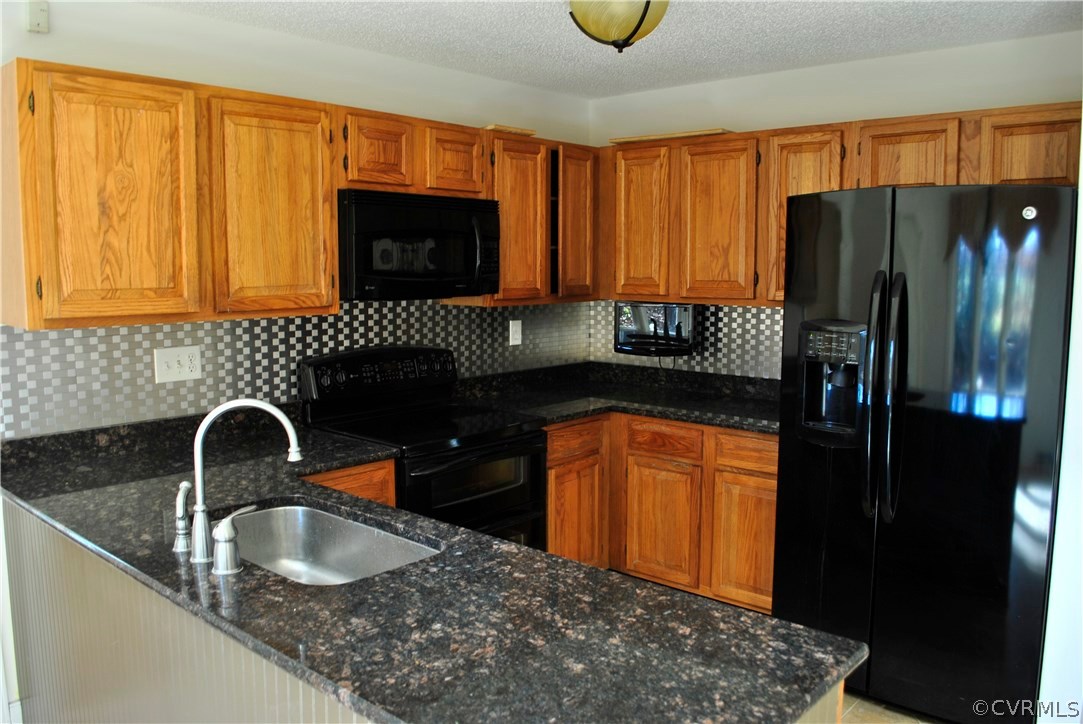 13902 North Point Road Midlothian, VA 23112 - Photo 6 of 36 a kitchen with granite countertop a refrigerator and a sink