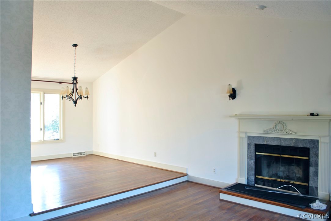 13902 North Point Road Midlothian, VA 23112 - Photo 10 of 36 an empty room with a fireplace and wooden floor