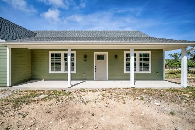 a view of a electric appliances in kitchen and empty room with wooden floor