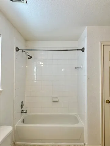 a bathroom with a shower and a bath tub