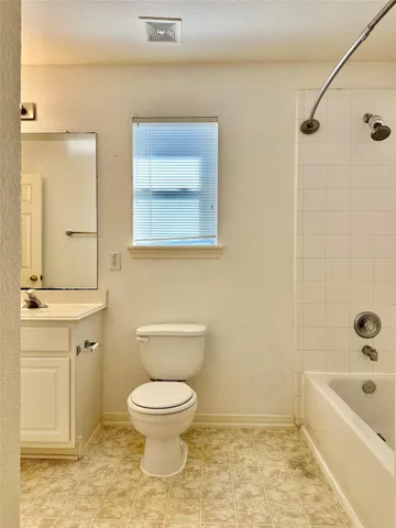 a bathroom with a toilet a sink a mirror and bathtub