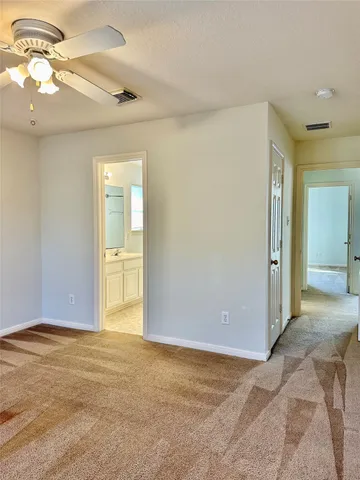 a view of a big room with closet and a chandelier fan