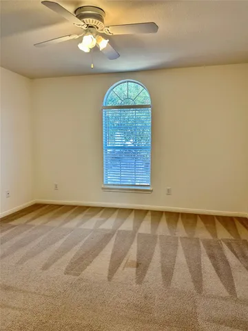 an empty room with a fireplace and wooden floor