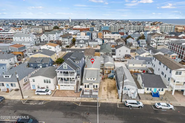 an aerial view of residential houses with city view