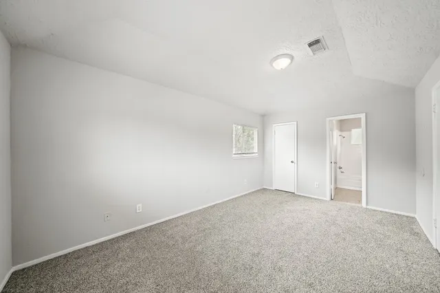 an empty room with windows and closet