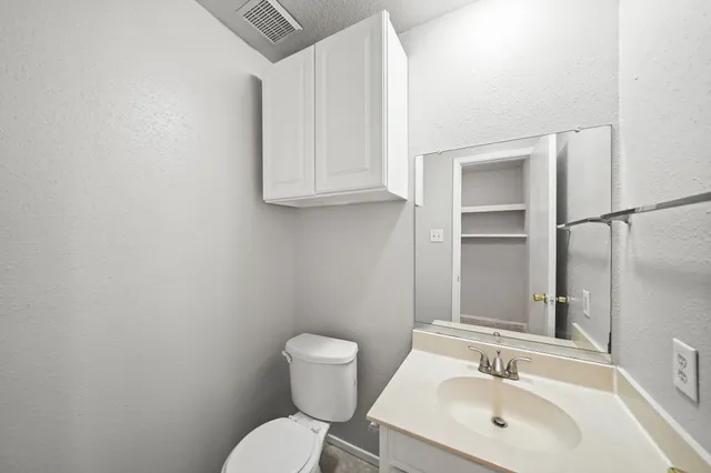 a bathroom with a sink a toilet and a mirror
