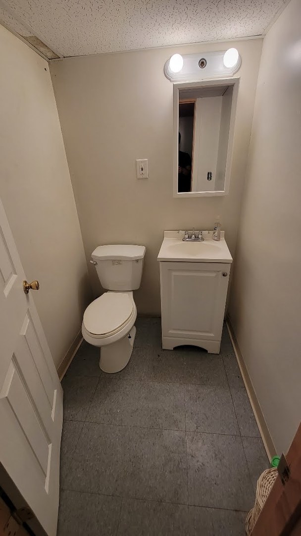 1400 Gardner Road Westchester, IL 60154 - Photo 9 of 12 a bathroom with a toilet sink and mirror