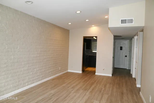 a view of hallway with wooden floor