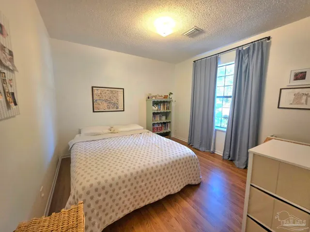 a bedroom with a large bed and a window