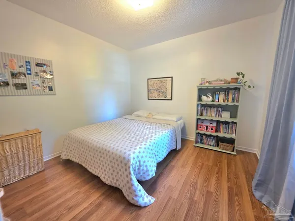 a bedroom with a bed and a book shelf