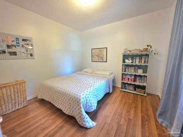 a bedroom with a bed and a book shelf