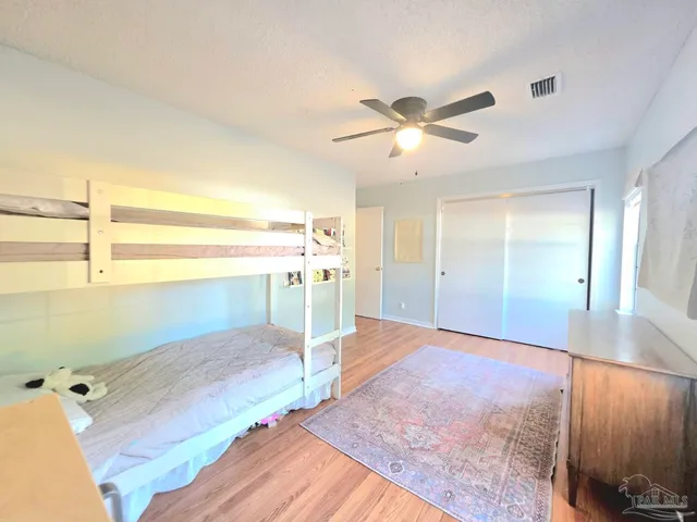 a view of a room with a ceiling fan