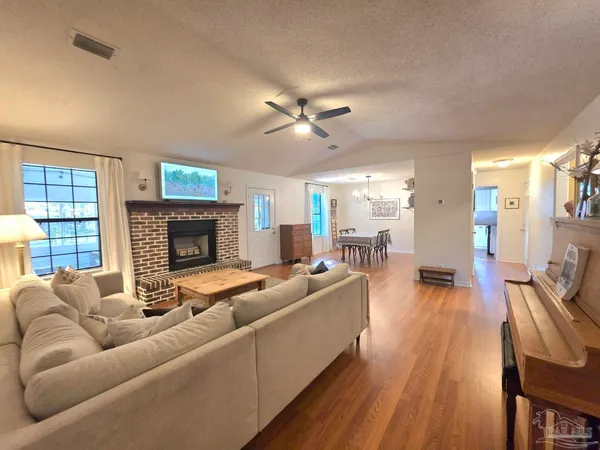 a living room with furniture fireplace and a flat screen tv
