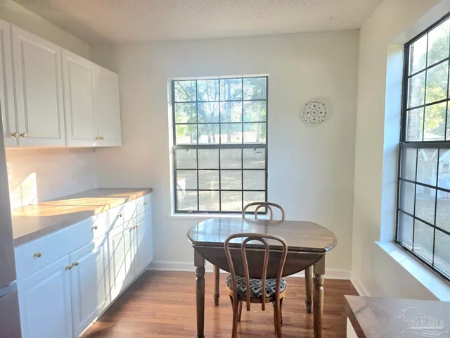 a view of a dining room with furniture window and wooden floor