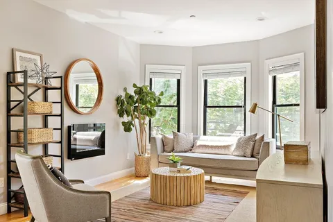 a living room with furniture a window and a large window