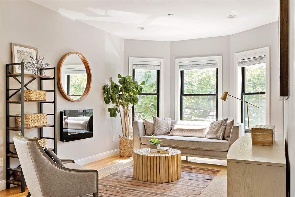 a living room with furniture a window and a large window