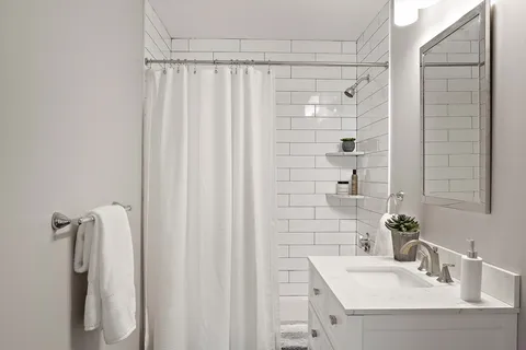 a bathroom with a shower and a sink