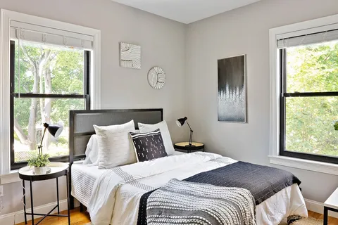 a bedroom with a bed and a window