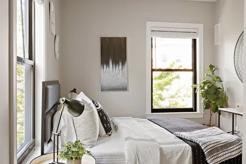 a bedroom with a bed and a window