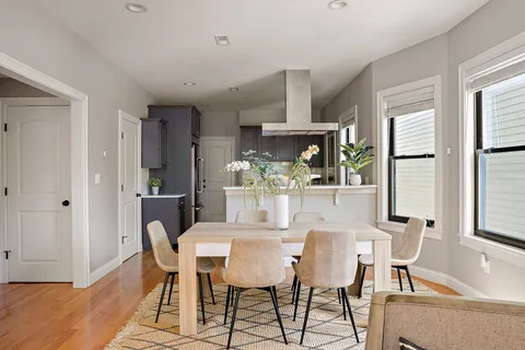 a view of a dining room with furniture and window