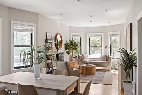 a dining room with furniture and wooden floor