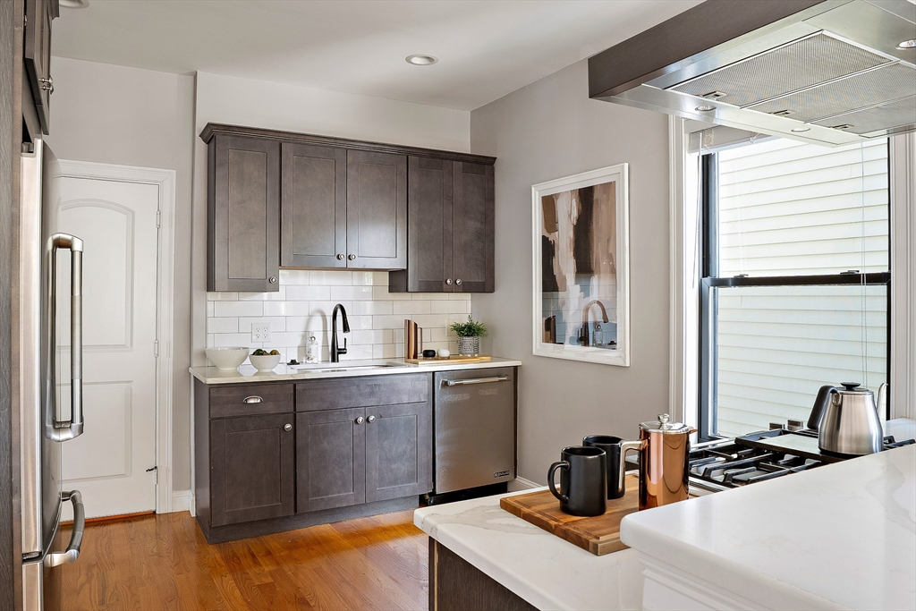 51 Dudley Street, Unit 2 Cambridge, MA 02140 - Photo 9 of 25 a kitchen with stainless steel appliances a sink a stove and a refrigerator
