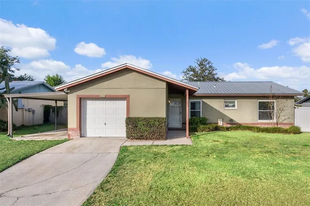 a front view of house with yard and green space