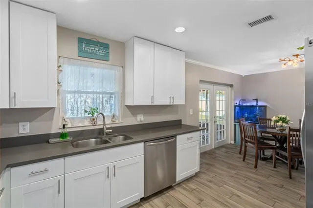 a kitchen with granite countertop a sink cabinets and window