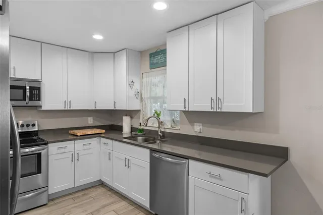 a kitchen with appliances cabinets and a sink