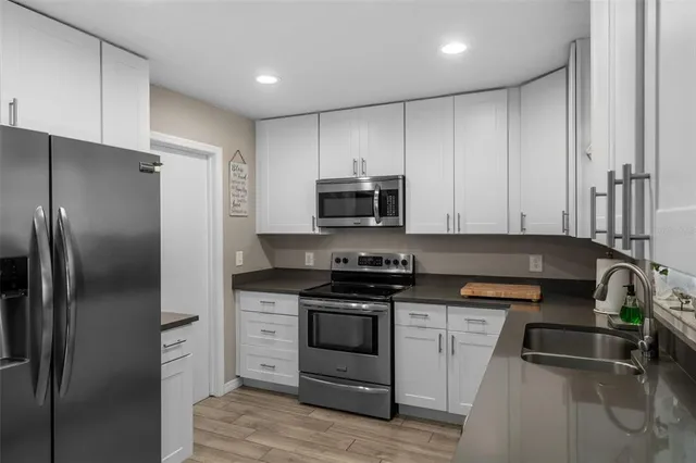 a kitchen with a refrigerator stove and microwave