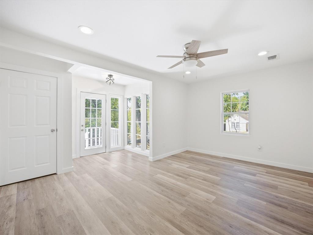 6933 Hatch Road Lake Worth, TX 76135 - Photo 8 of 28 Wood-finish flooring, recessed lighting, ceiling fan, white paneled doors, and French doors with transom windows