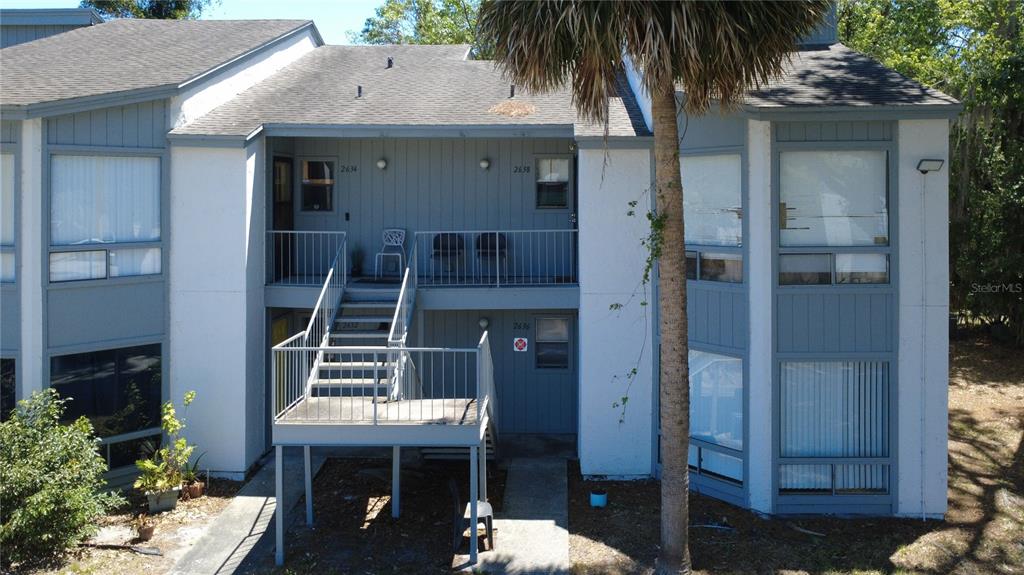 2636 Lemon Tree Lane, Unit 2636 Orlando, FL 32839 - Photo 11 of 51 a front view of a house with a yard