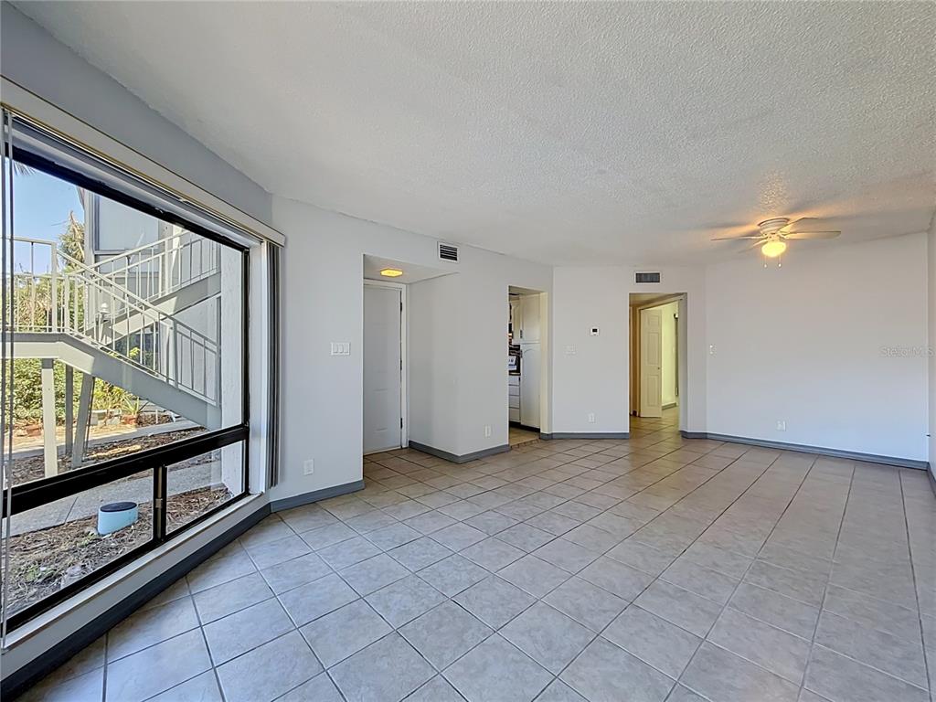 2636 Lemon Tree Lane, Unit 2636 Orlando, FL 32839 - Photo 16 of 51 a view of a room with an empty space and a large window