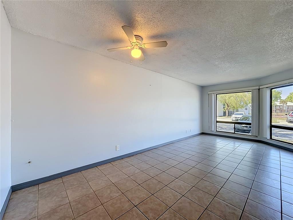2636 Lemon Tree Lane, Unit 2636 Orlando, FL 32839 - Photo 18 of 51 an empty room with windows and fan