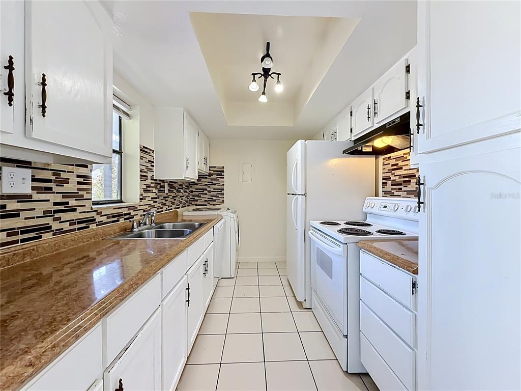 2636 Lemon Tree Lane, Unit 2636 Orlando, FL 32839 - Photo 19 of 51 a large kitchen with stainless steel appliances granite countertop a stove a sink dishwasher and a refrigerator