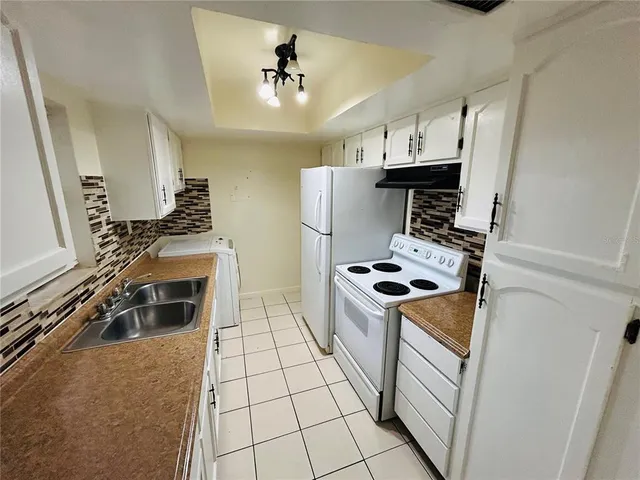 a kitchen with stainless steel appliances granite countertop a stove and a refrigerator