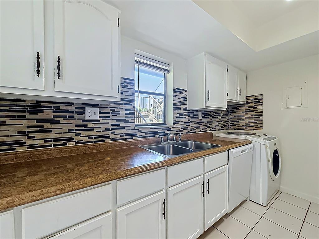 2636 Lemon Tree Lane, Unit 2636 Orlando, FL 32839 - Photo 23 of 51 a kitchen with sink and cabinets