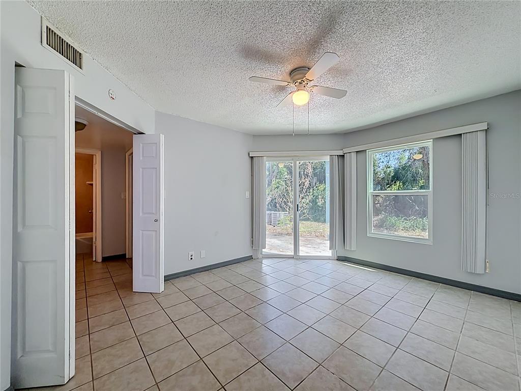 2636 Lemon Tree Lane, Unit 2636 Orlando, FL 32839 - Photo 31 of 51 a view of an empty room and window and chandelier fan